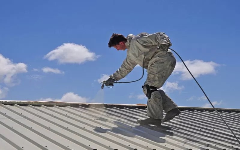Roof coating application on a metal roof surface