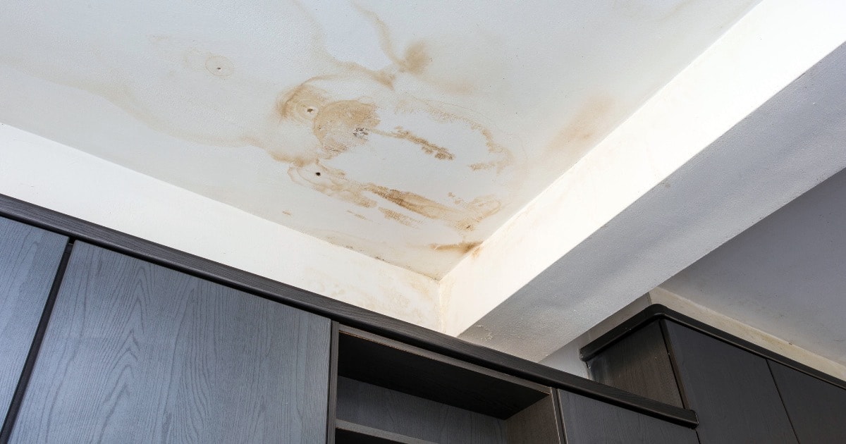Ceiling water stains from roof leak damage inside a property