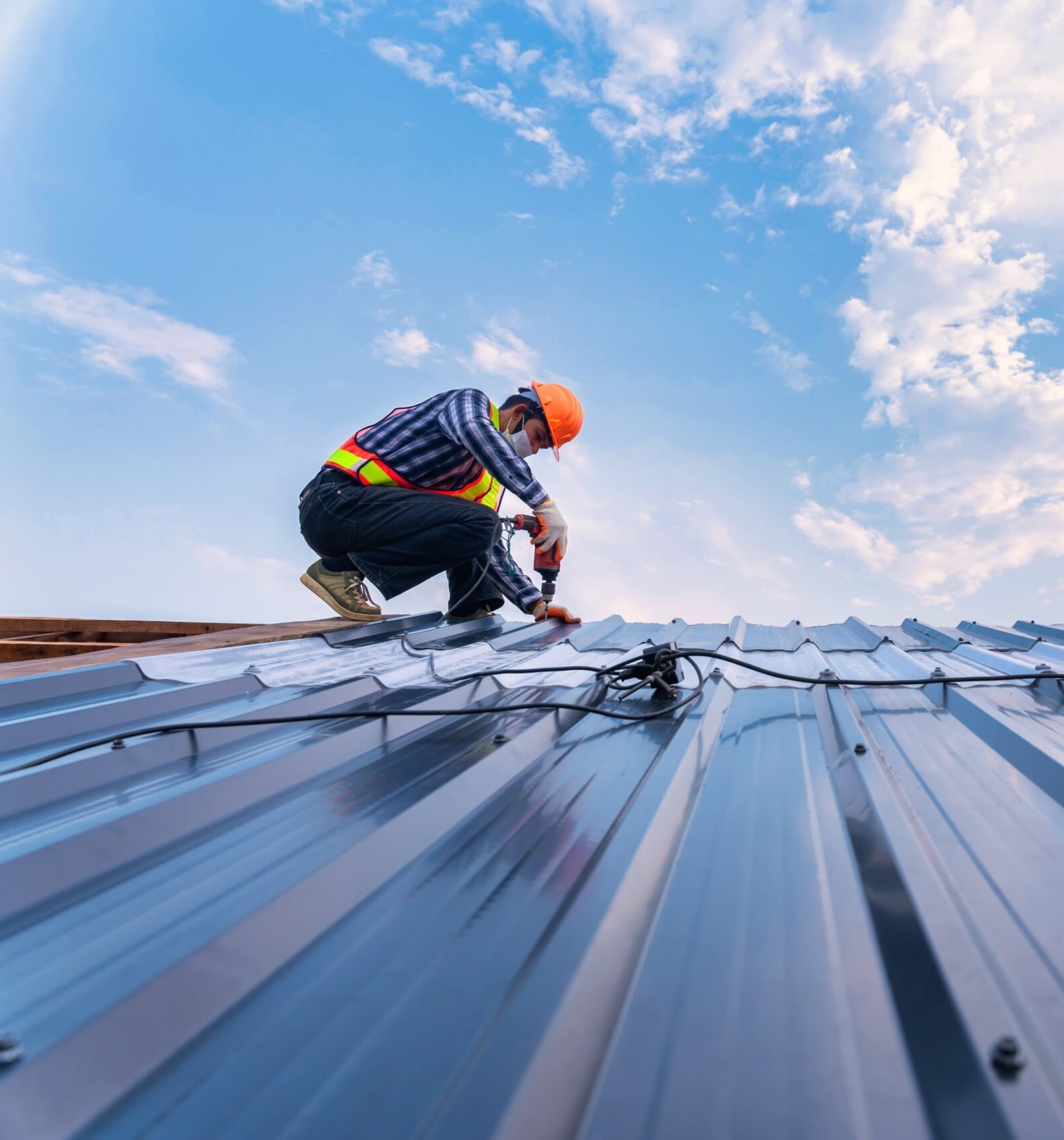 Roofer working on a commercial metal roof
