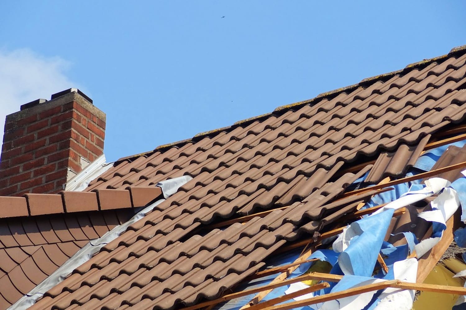 Storm-damaged tiled roof requiring assessment