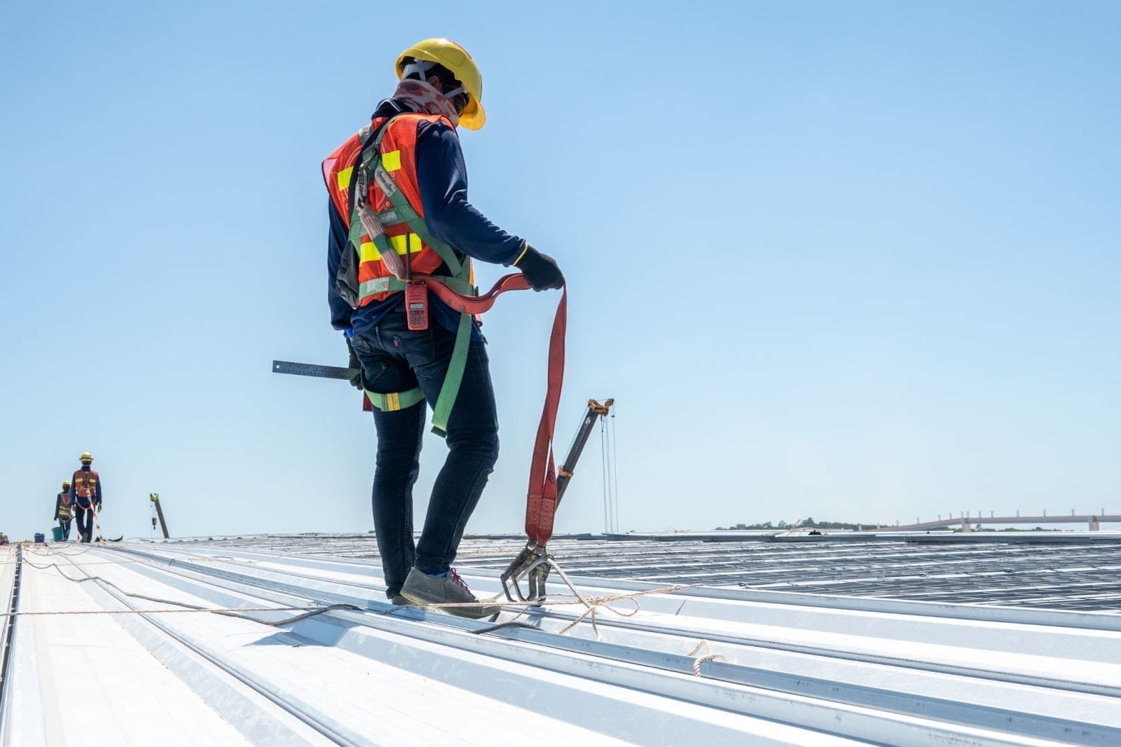 Commercial roof maintenance on a large metal roof