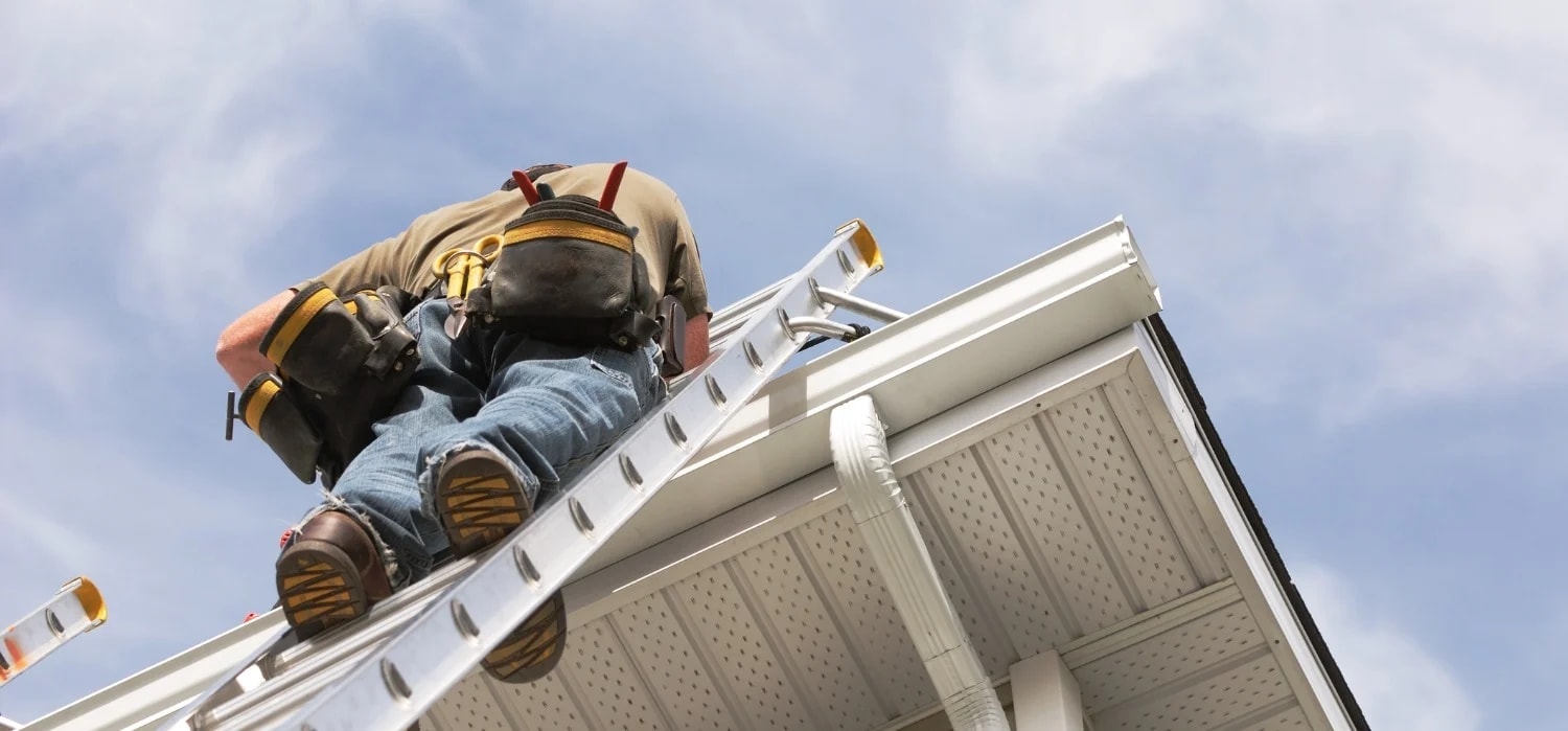 Roof maintenance work near the gutter line